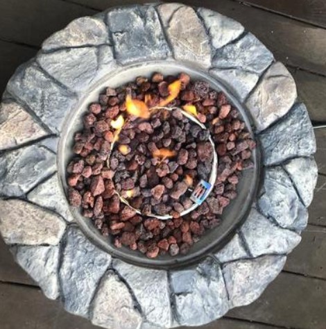 Backyard Stone Fire Pit-Peaktop fire pit top view with lava rocks and fire